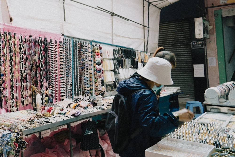 a person looking at a display of jewelry