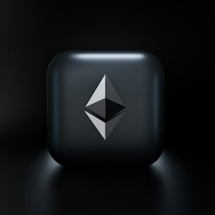 A sleek, modern design featuring a three-dimensional geometric shape resembling the Ethereum logo, centered on a glossy dark gray square with subtle lighting effects. The background fades into a deep black, highlighting the central emblem.
