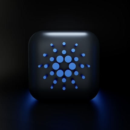 A digital, stylized design featuring a square-shaped object with rounded edges, displaying a symmetric arrangement of various-sized blue circles on its surface, set against a dark background.