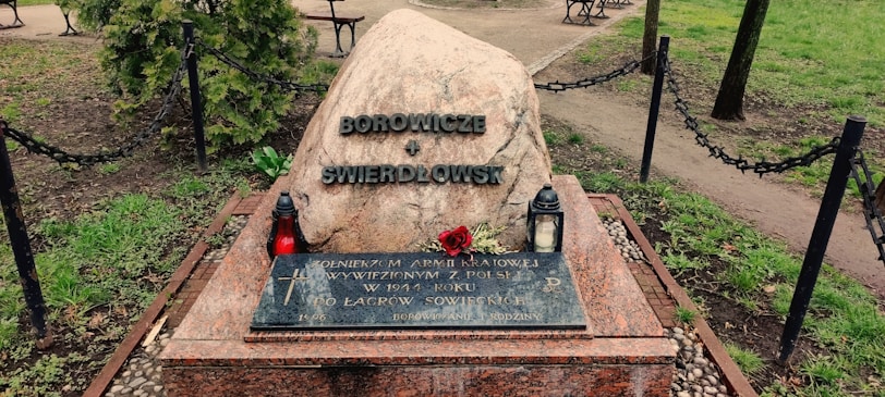 A peaceful memorial stone surrounded by flowers.