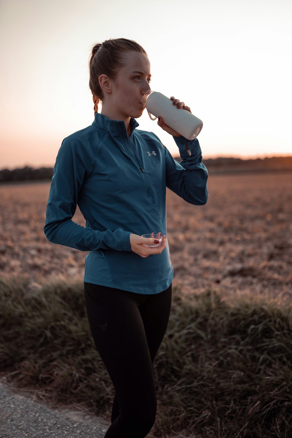 a person drinking from a cup