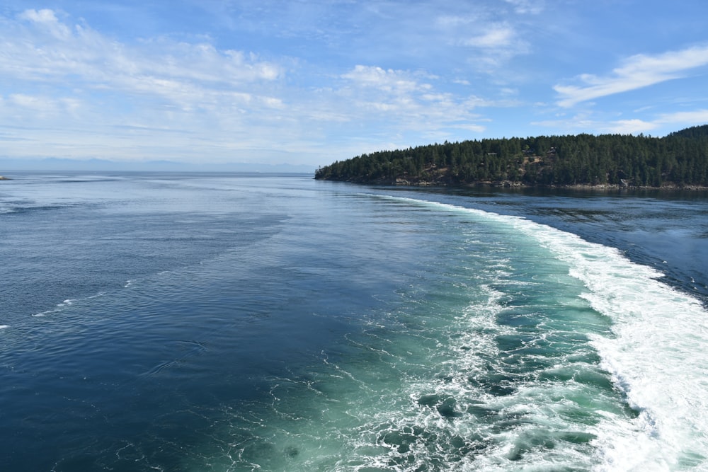 a body of water with a land in the background