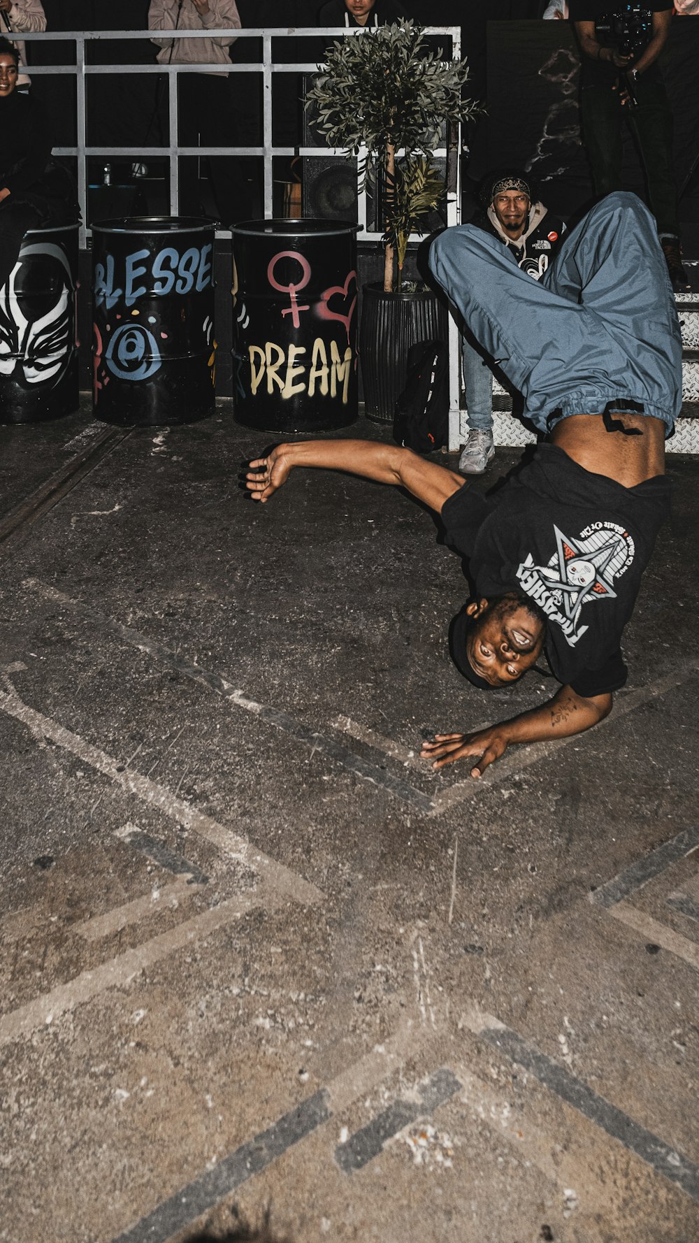 a man doing a handstand on a skateboard