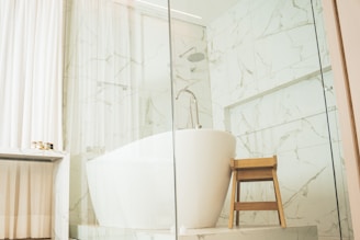 a bathtub and stool in a bathroom