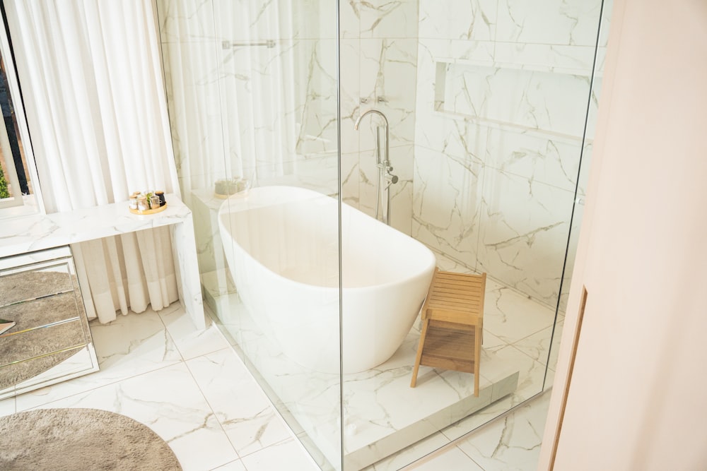 a bathroom with a tub and stool