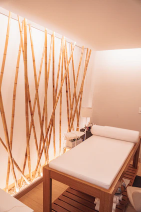 Elegant spa treatment room with soft lighting and plush white towels