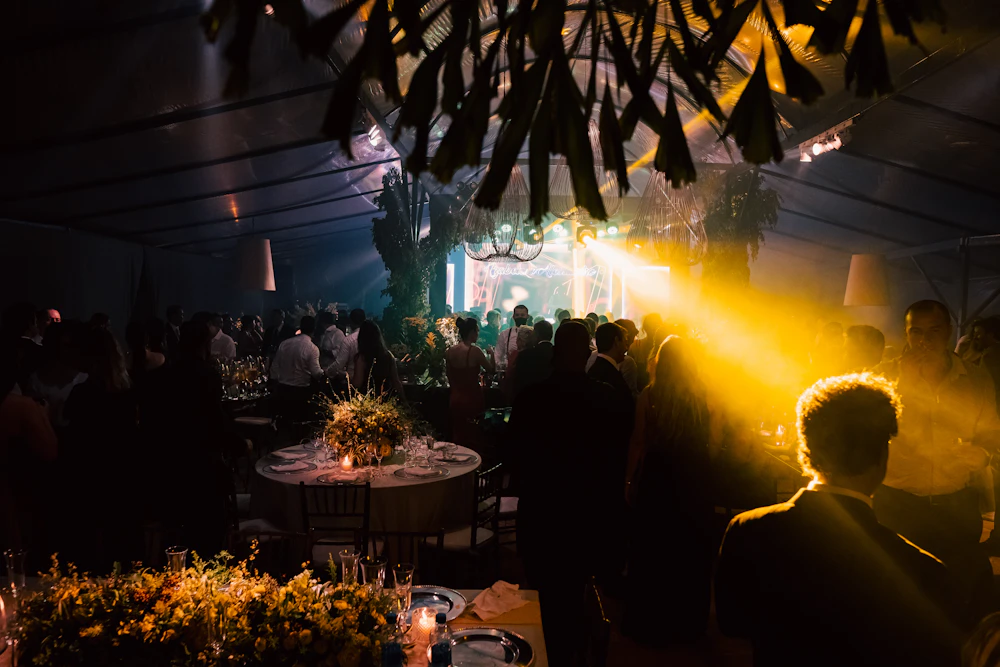 Corporate celebration event with festive lighting and guests