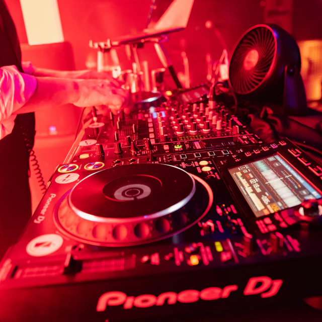 DJ turntable lit by a red light