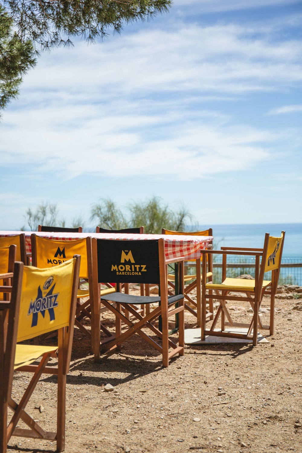 a table and chairs on a beach