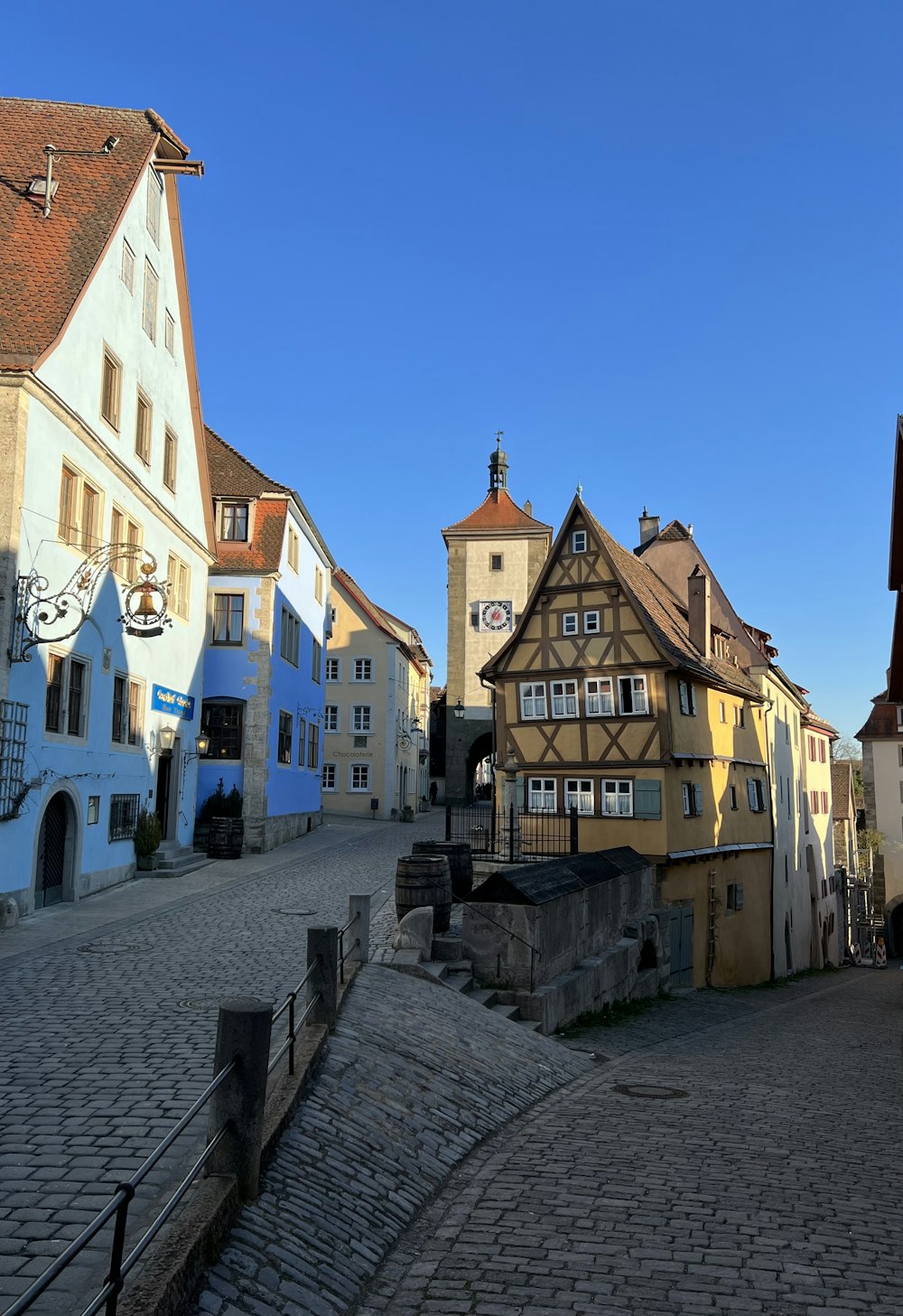 a cobblestone street with buildings on either side of it