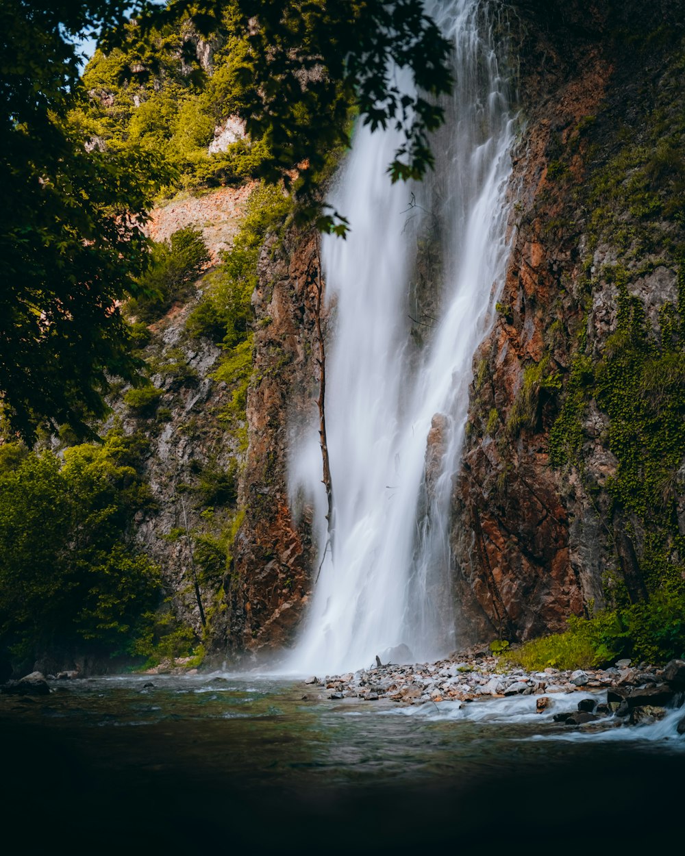 a waterfall over a rocky cliff