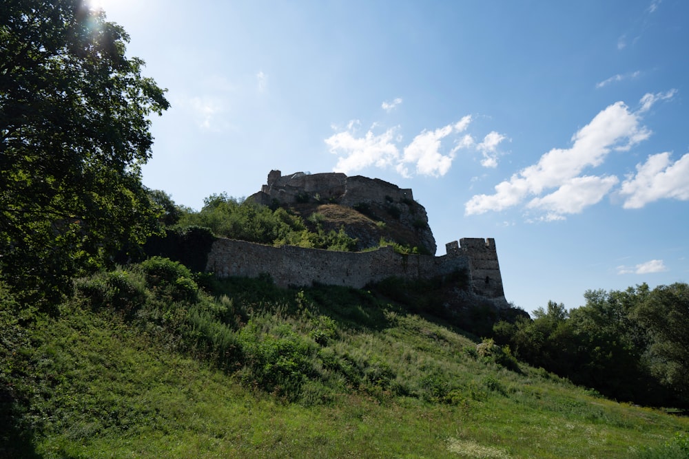 a stone building on a hill