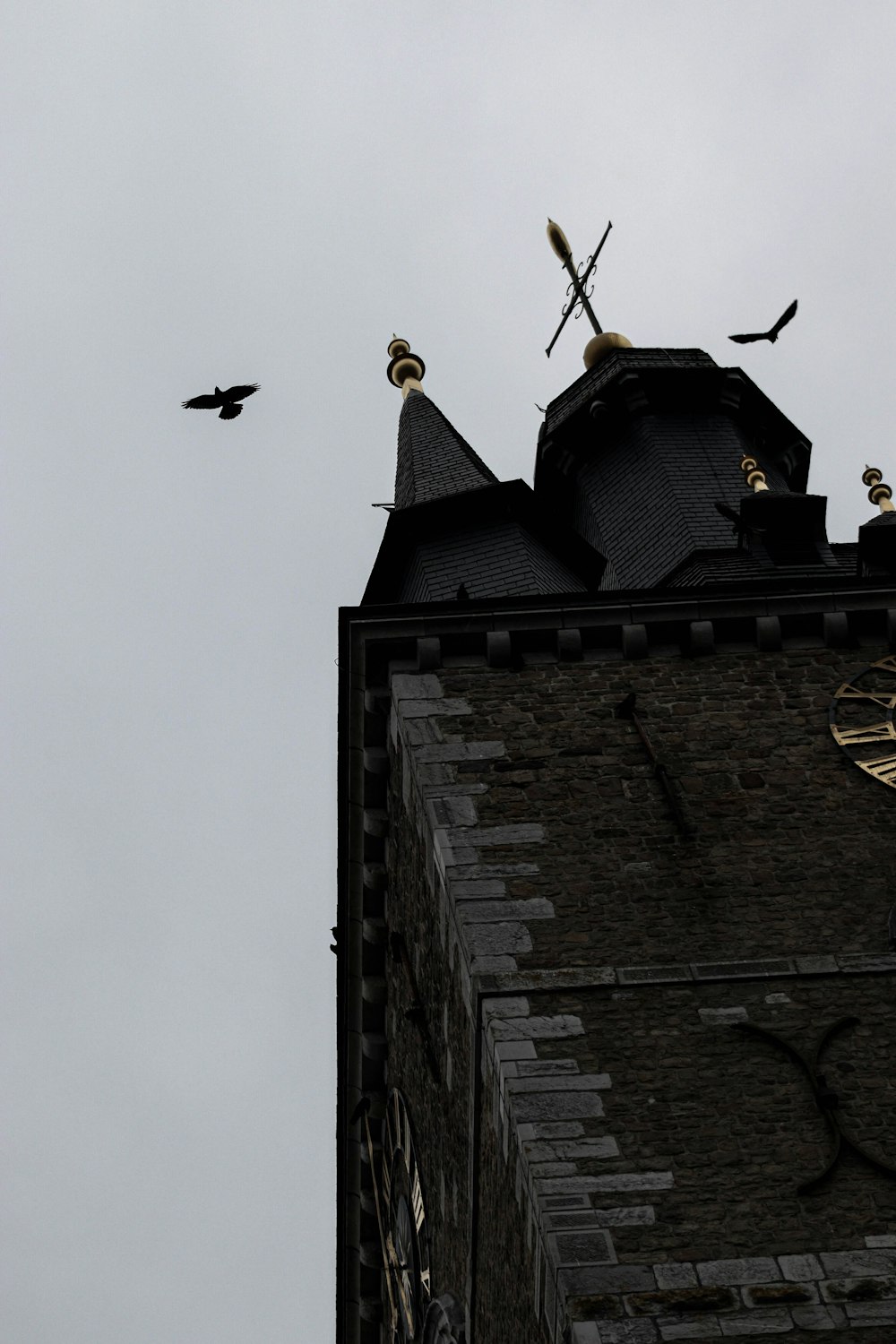 a brick building with birds flying around