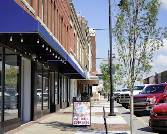 a sidewalk with cars parked on the side