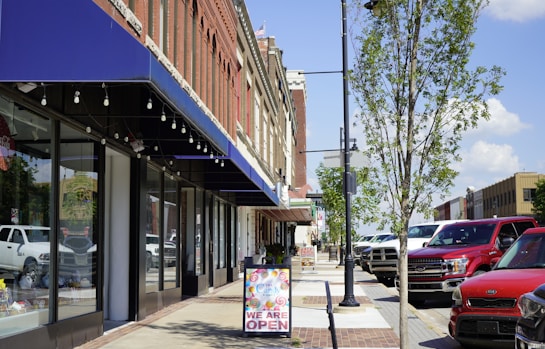 a sidewalk with cars parked on the side