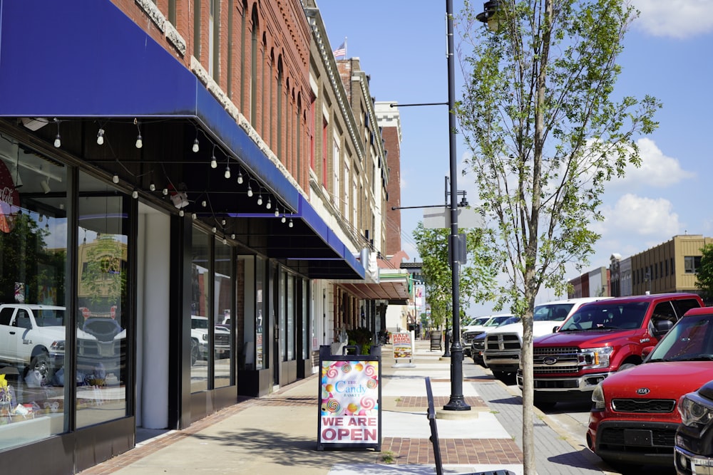 a sidewalk with cars parked on the side