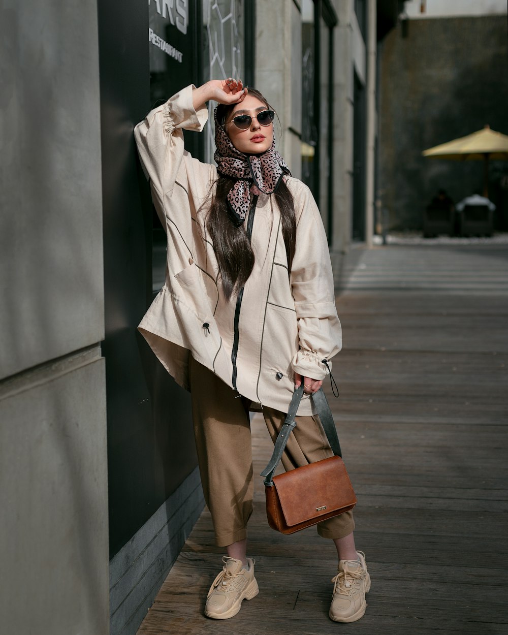 a woman wearing a coat and sunglasses