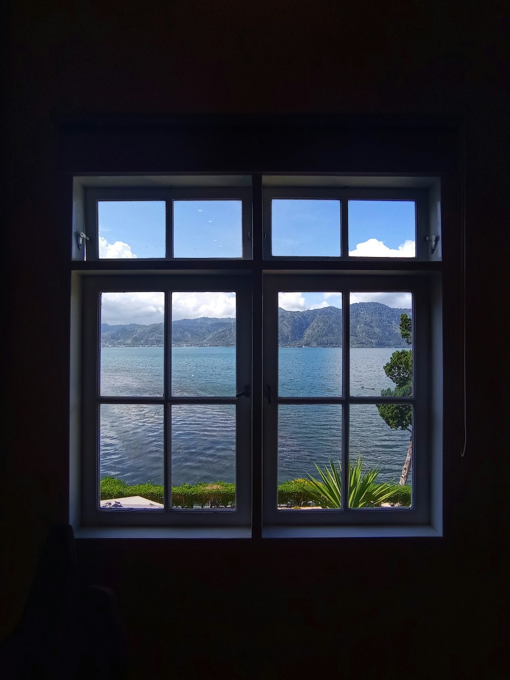 a window with a view of the mountains and the sky