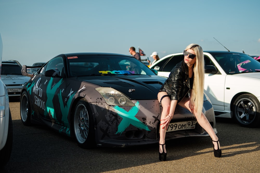 a person posing next to a car