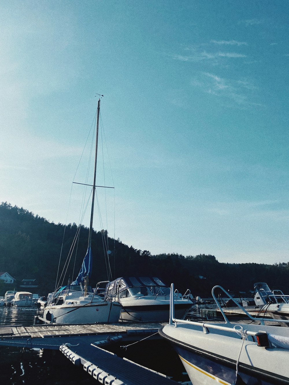 a group of boats sit on the shore of a lake