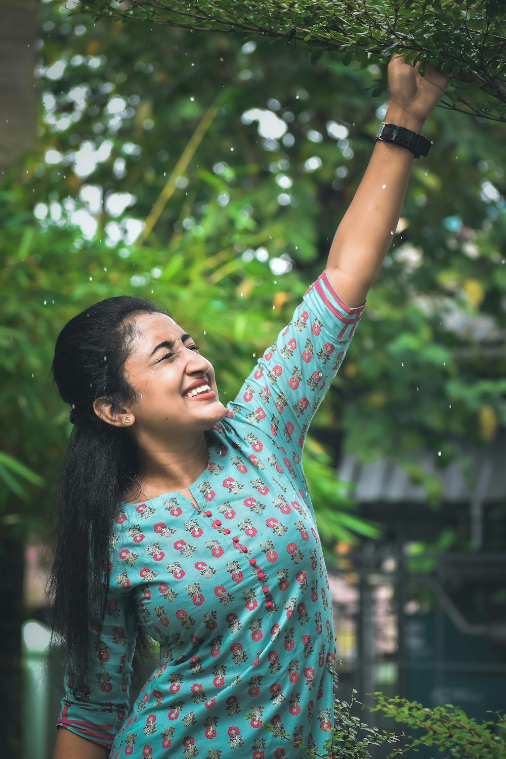 a woman holding a tree branch