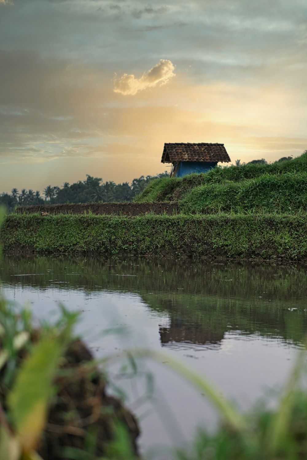 a house on a hill by a lake