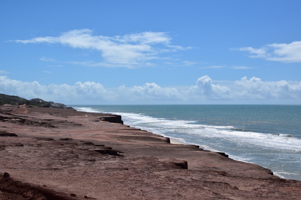 a sandy beach with waves crashing on it