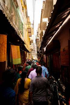a crowd of people walking through a narrow alley