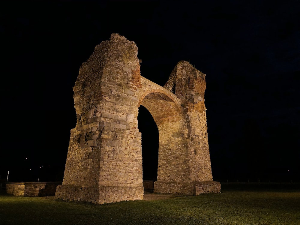 a stone structure with a dark background