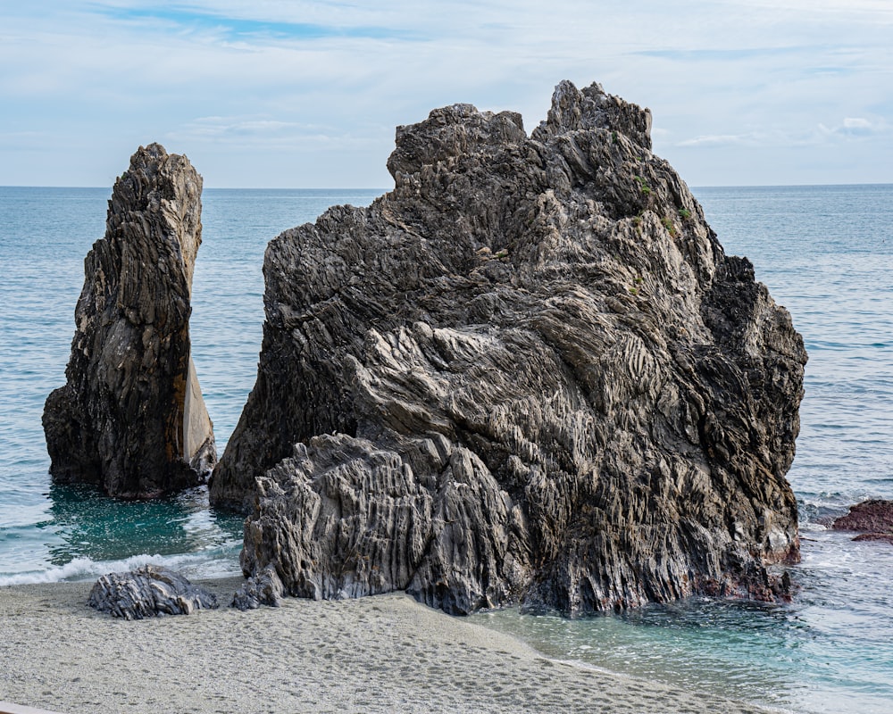 a group of large rocks in the water