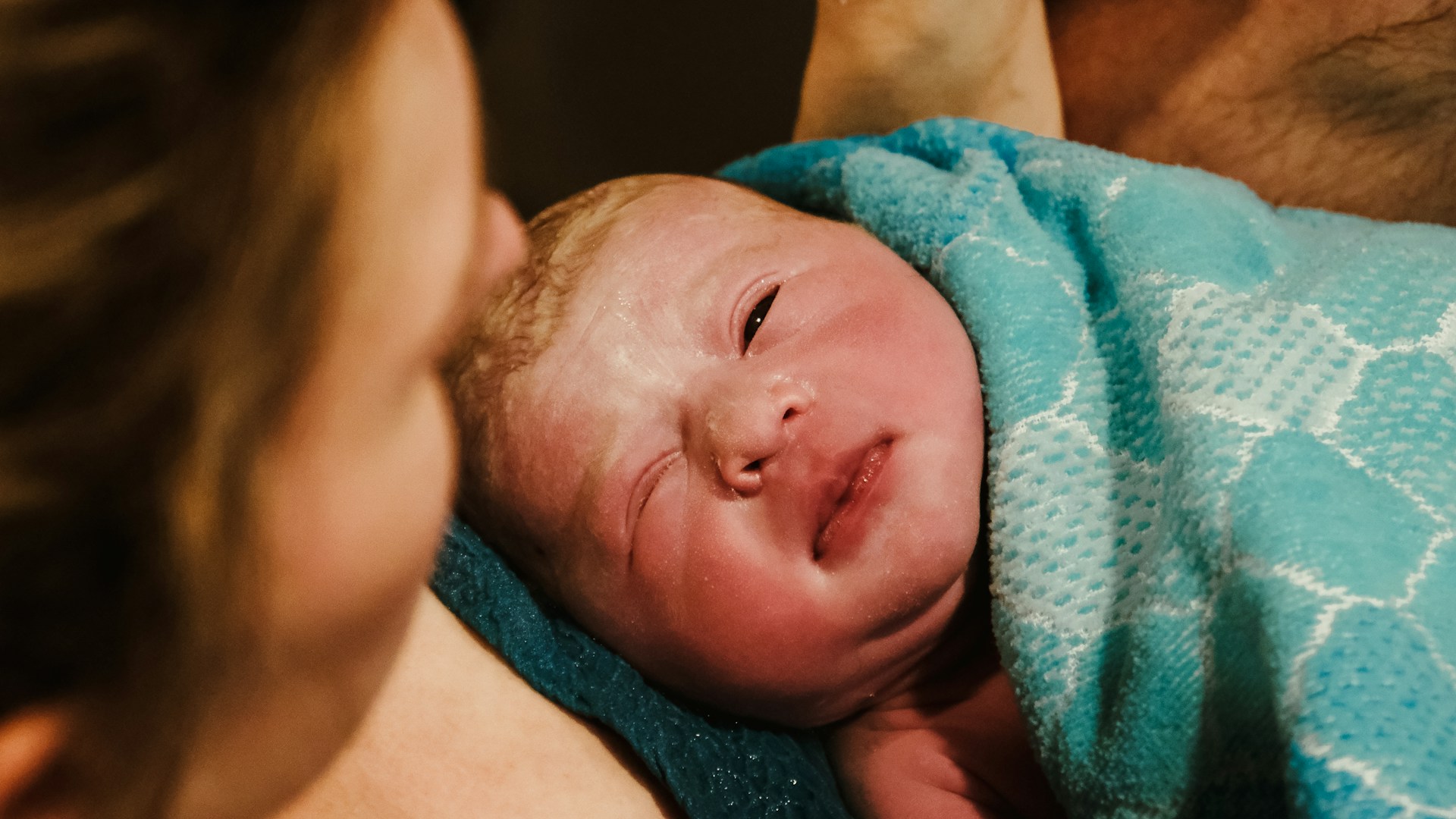 a baby lying on a blanket