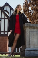 A happy graduate posing confidently in a sleek dress from Raucco's collection.