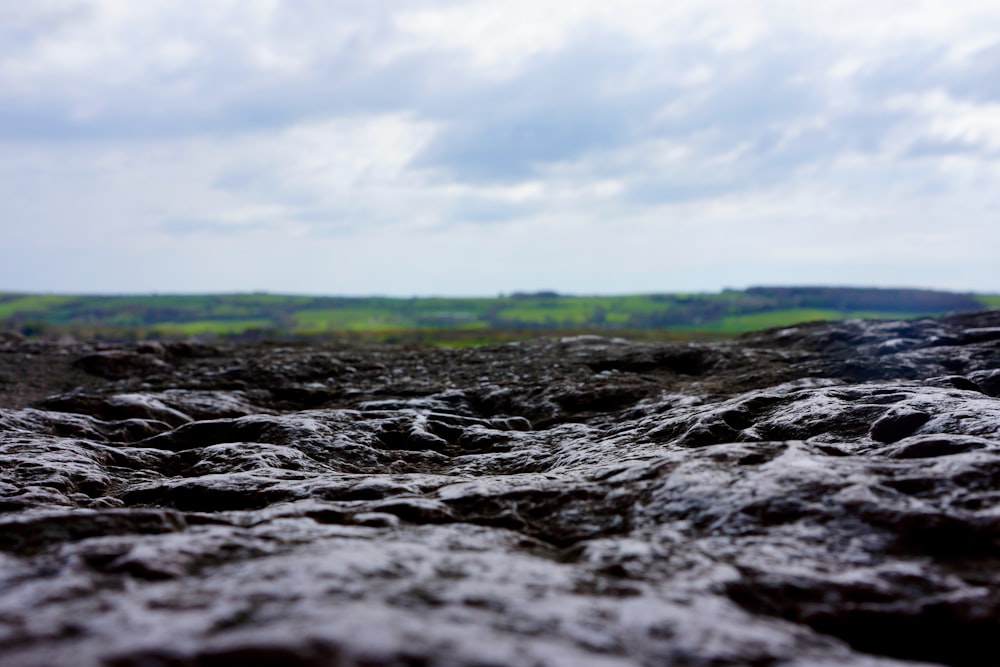 a rocky beach with a cloudy sky