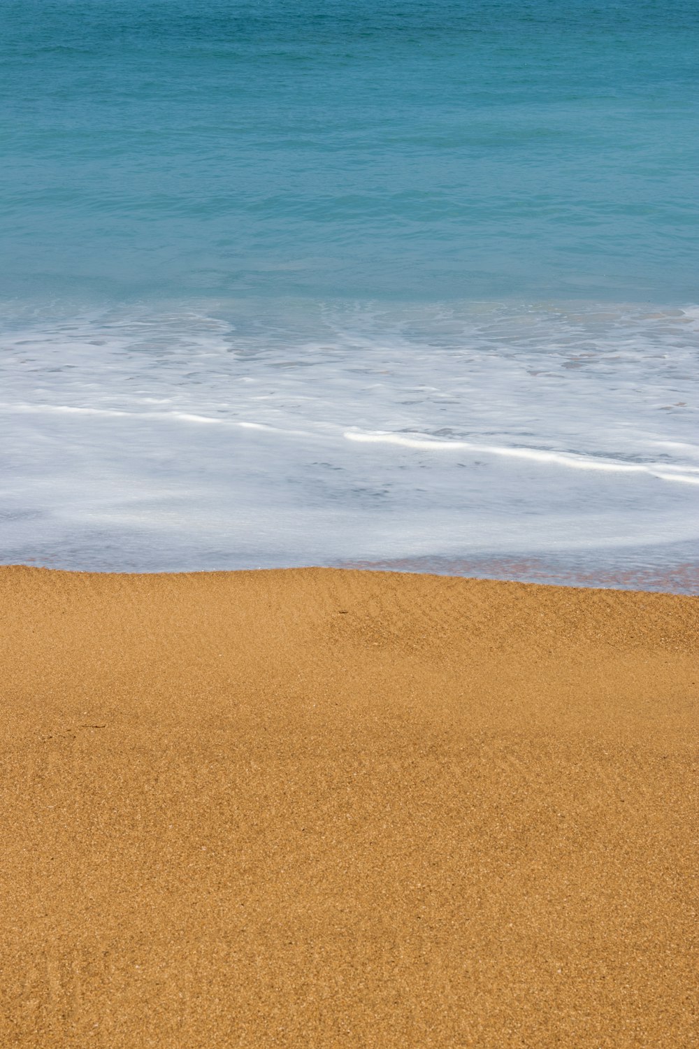 a sandy beach with waves