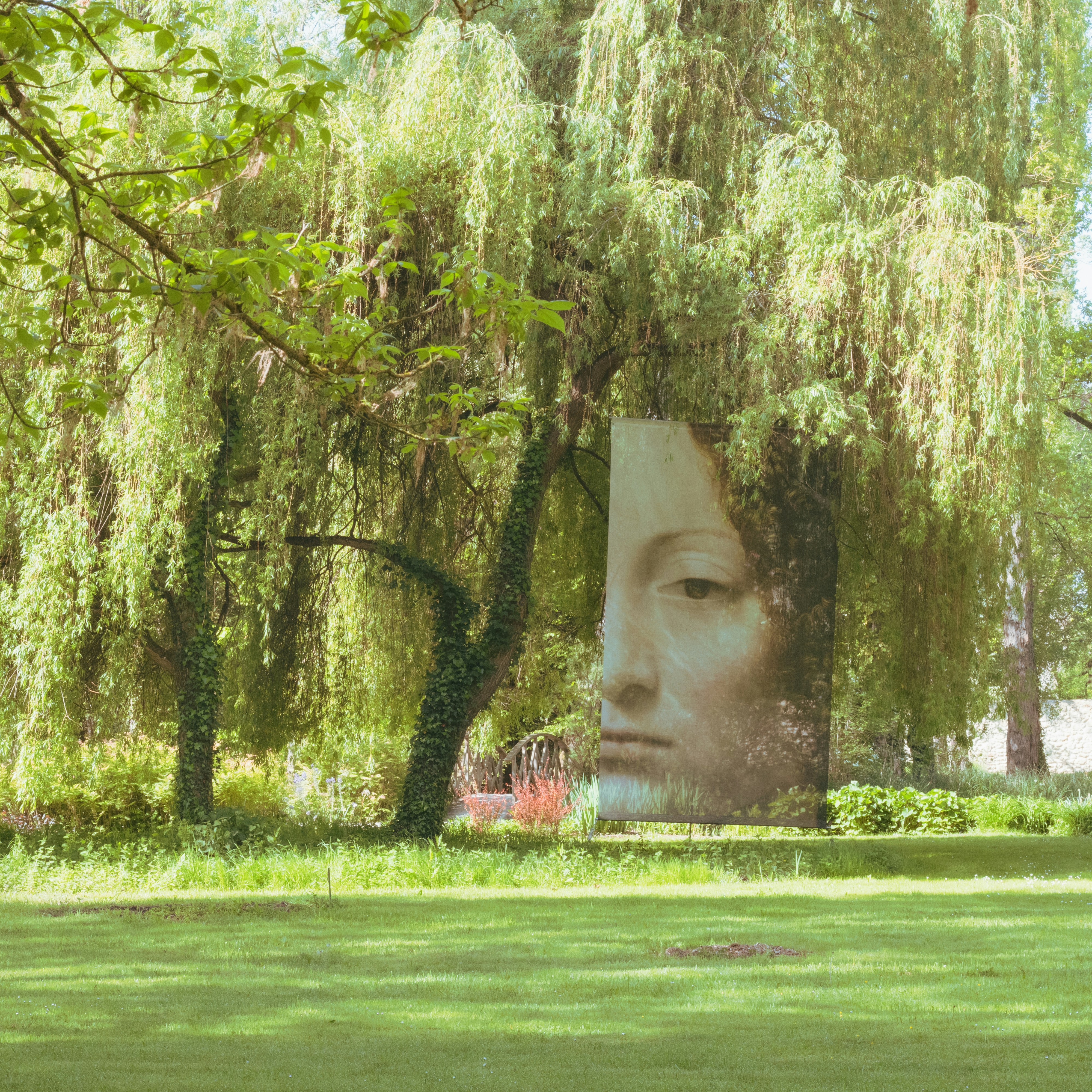 a statue of a person with trees in the background