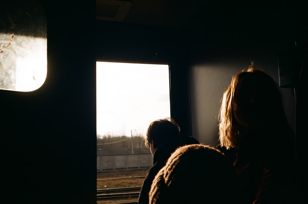 a couple of people looking out a window