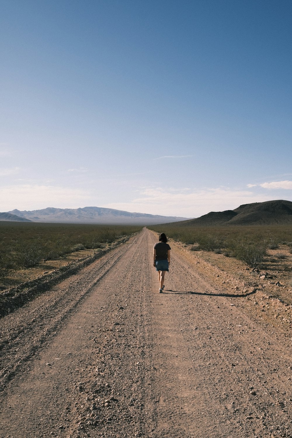 a person walking on a dirt road
