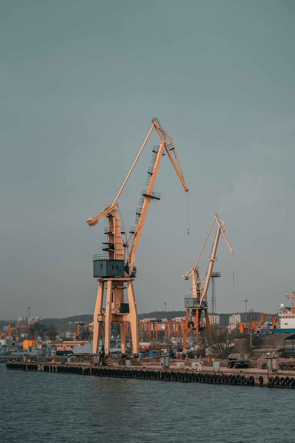 a group of cranes on a dock