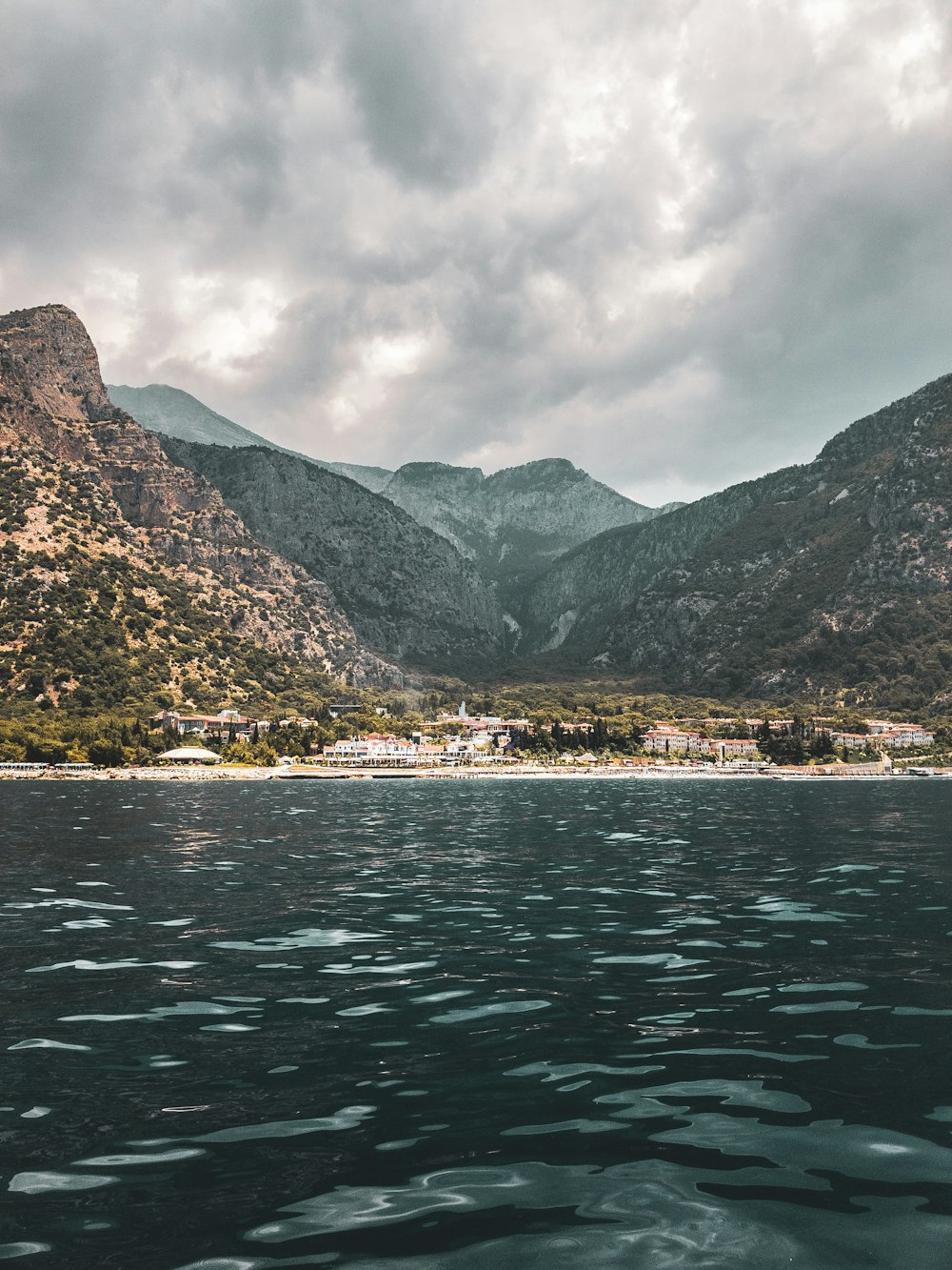 a body of water with mountains in the back