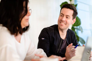 A friendly property manager discussing lease terms with a smiling landlord.