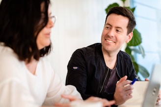 A friendly consultant discussing bookkeeping details with a client.