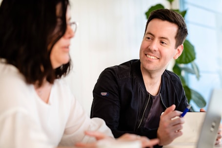 A friendly professional discussing a project estimate with a smiling client.