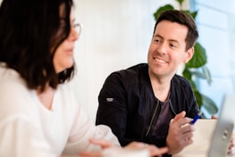 A happy landlord and tenant discussing rental terms.