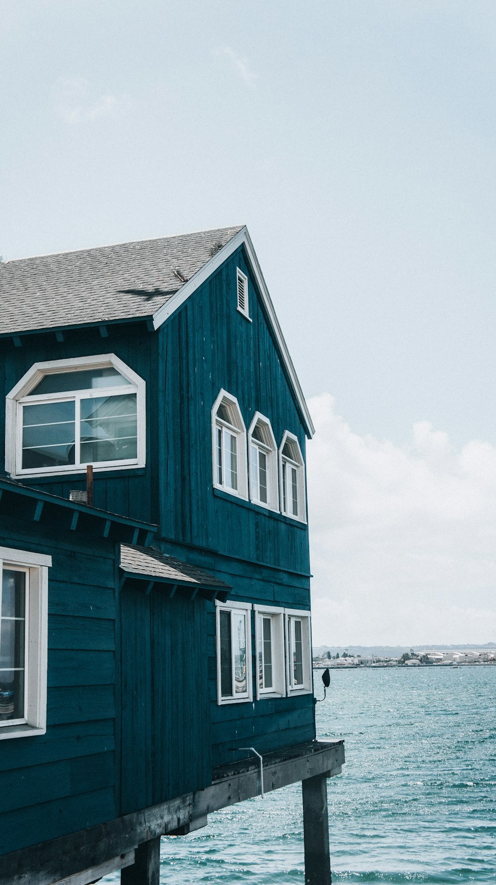 a blue house on a dock
