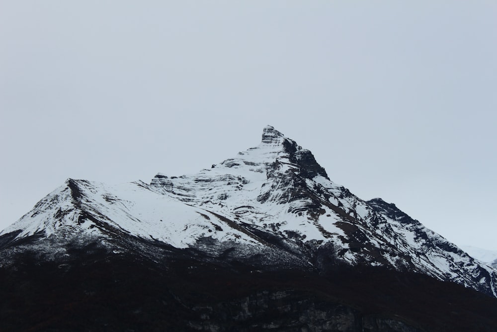 a snowy mountain with a cloudy sky