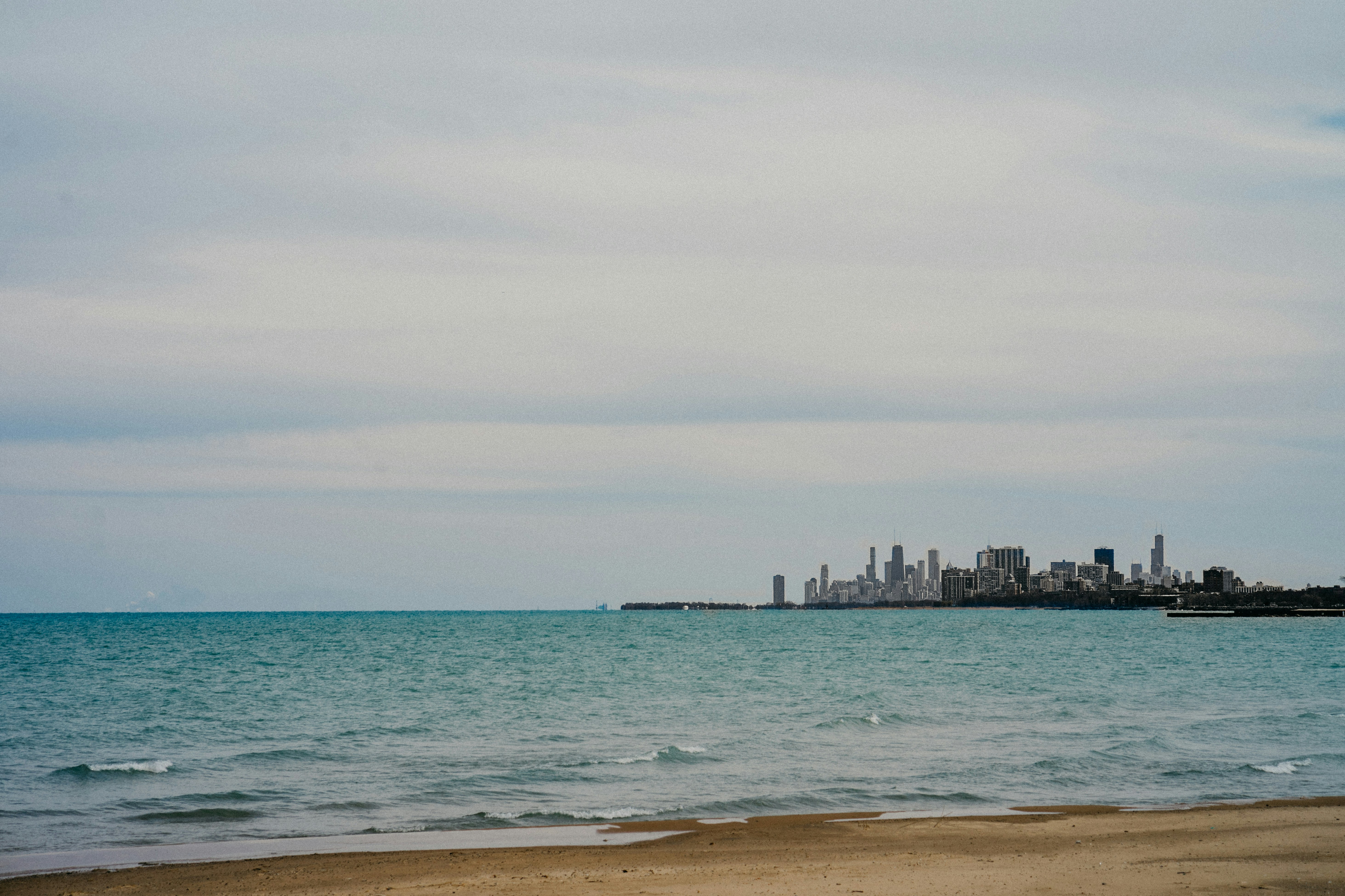 a beach with a city in the background