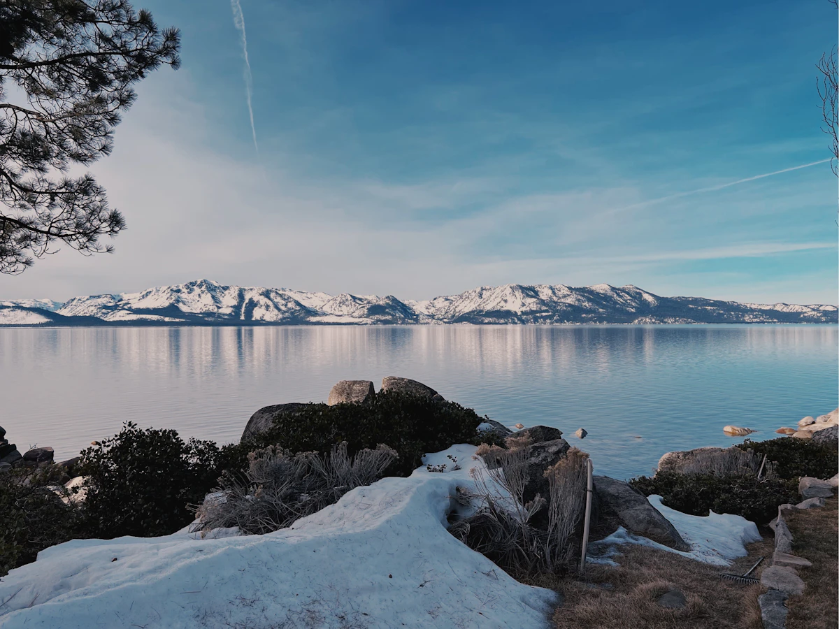 Lake Tahoe in winter with snow covered peaks around the blue water