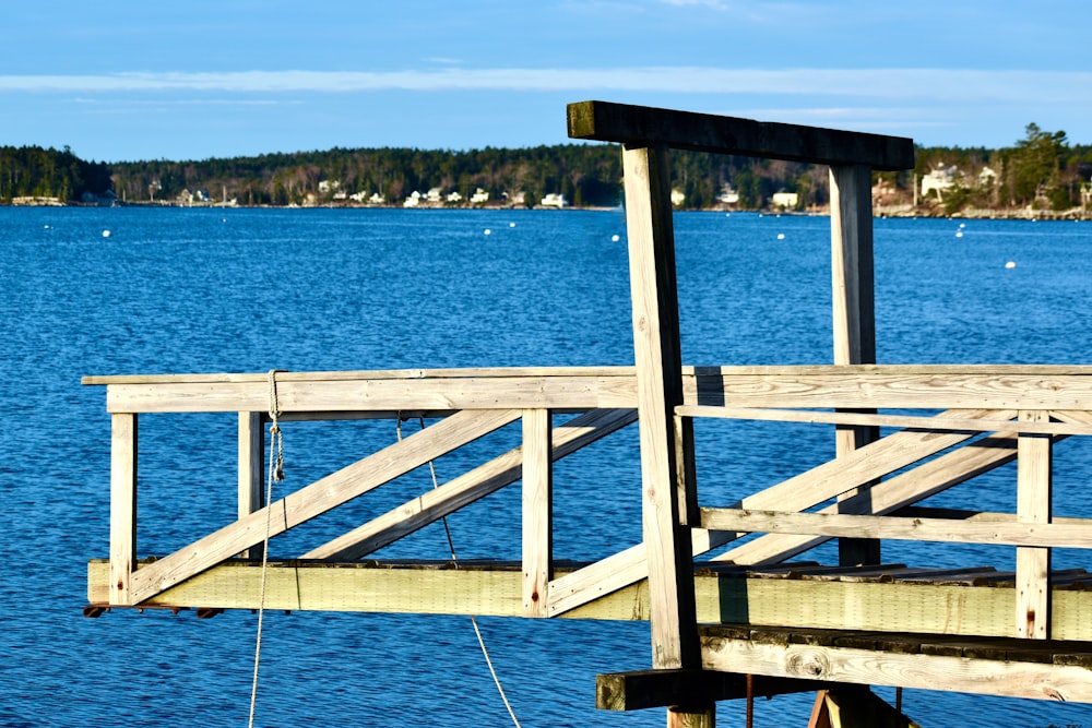 a wooden railing on a dock over water