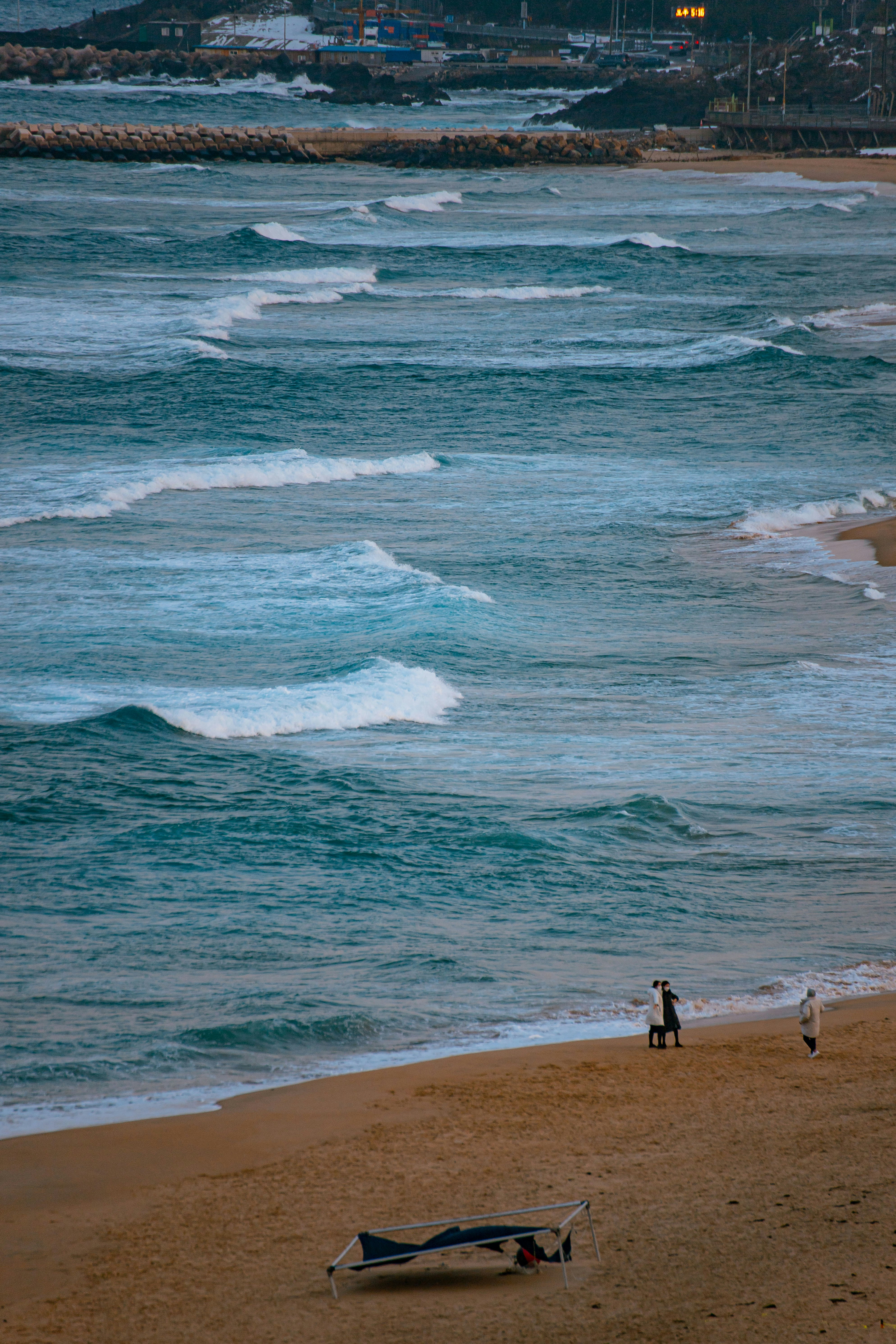 a person on a beach with a surfboard