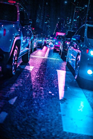A panoramic shot of a bustling futuristic street filled with flying cars and vibrant neon lights.